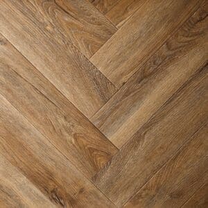 Close up of Textures LVT Distressed Oak Herringbone TH06 luxury vinyl flooring showing the herringbone pattern.