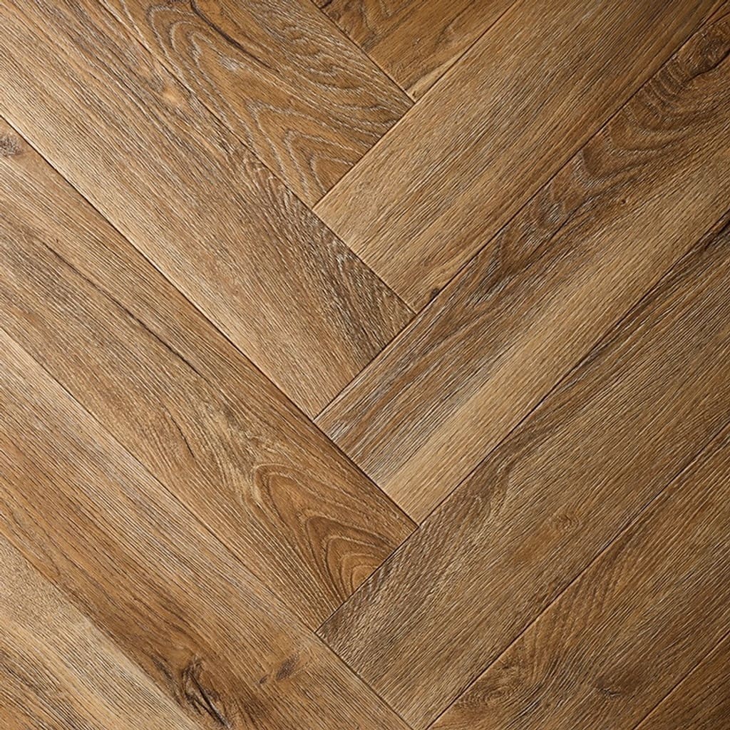 Close up of Textures LVT Distressed Oak Herringbone TH06 luxury vinyl flooring showing the herringbone pattern.