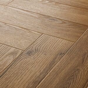 Close up of installed Textures LVT Honey Oak Herringbone TH07 luxury vinyl flooring