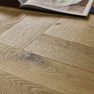 Textures LVT Sycamore Herringbone TH01 close-up showing the wood grain and herringbone pattern.