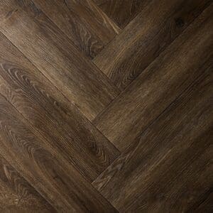 Textures LVT Tudor Oak Herringbone TH03 flooring close-up showing the herringbone pattern.