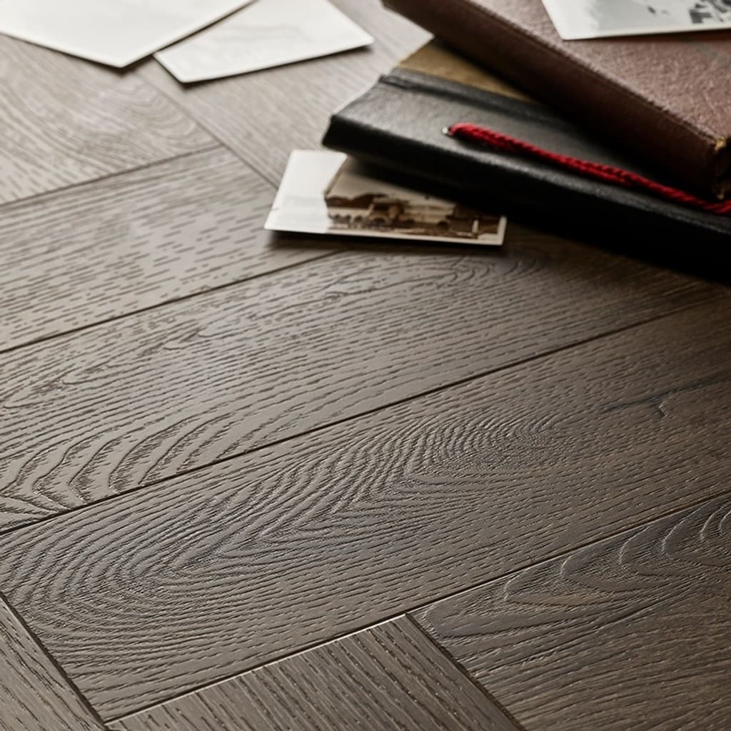 Textures LVT Tudor Oak Herringbone TH03 flooring close-up showing wood grain and texture.