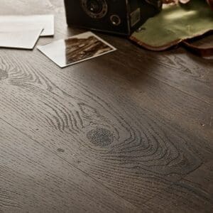 Textures LVT Tudor Oak Plank TP03 installed floor detail with vintage camera and photos