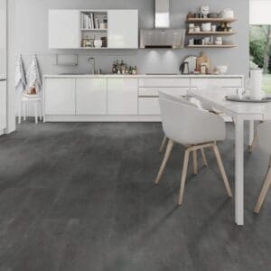 Modern white kitchen featuring Cement Dark Grey stone effect flooring