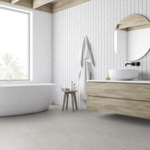 Cement Terrazzo Beige flooring installed in a modern white bathroom with a freestanding tub