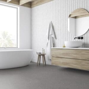 Cement Terrazzo Grey flooring installed in a modern white bathroom with a freestanding tub