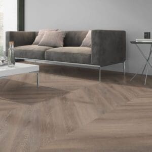 Close up detail of Cerused Oak Dark Natural Chevron flooring in a furnished interior setting