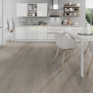 Bright white kitchen and dining space with English Oak Greige vinyl plank flooring