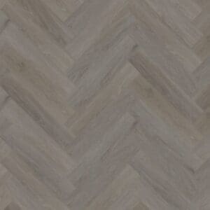 A top down view of English Oak Taupe Herringbone luxury vinyl flooring showing the intricate wood grain and parquet pattern.