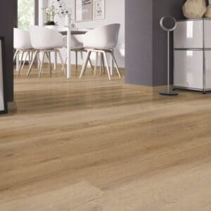 A low angle view of German Oak Natural flooring leading into a bright dining area with white furniture.