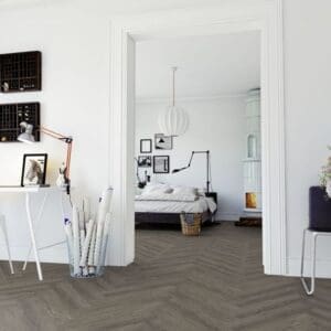 A bright home office featuring Manor Oak Natural Dark Herringbone flooring and white walls.