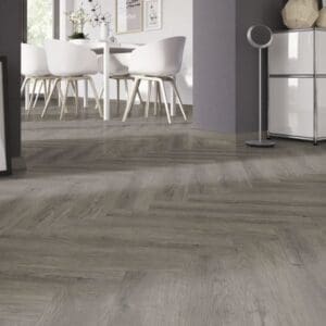 Manor Oak Natural Dark Herringbone flooring installed in a modern living room with white furniture.