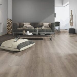 Modern living room featuring Noble Oak Greige flooring with grey sofa and minimalist decor