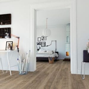 A modern bedroom and home office featuring Authentic Oak Natural flooring with white walls and contemporary furniture.