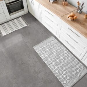 Contemporary kitchen area with Oxyde Grey vinyl tiles and white cabinetry.