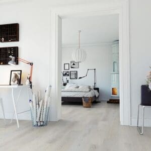 Modern bedroom interior featuring Sea Oak White flooring with white walls and minimalist furniture