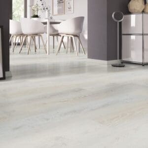 Contemporary dining area with Sea Oak White luxury vinyl flooring and white designer chairs