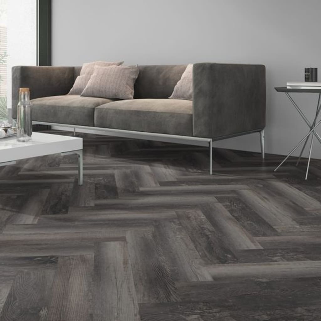 Close up of Smoked Pine Black Herringbone flooring in a contemporary lounge setting