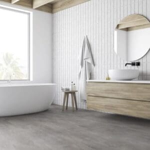 Modern bathroom featuring Origin Concrete Natural flooring with a white freestanding bathtub