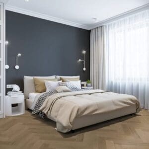 Modern bedroom featuring Prestige Oak Light Amber herringbone flooring with grey walls