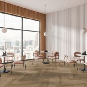 Prestige Oak Light Amber Chevron installed in a modern commercial dining space with pink chairs