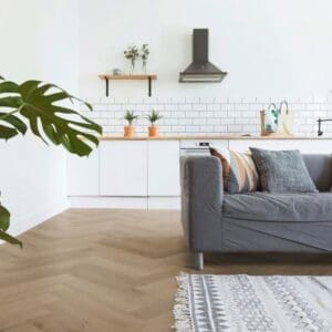 Open plan kitchen and living room with Prestige Oak Light Amber parquet flooring