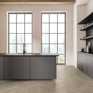 Modern kitchen featuring Raw Oak Light Natural herringbone flooring and dark grey cabinetry
