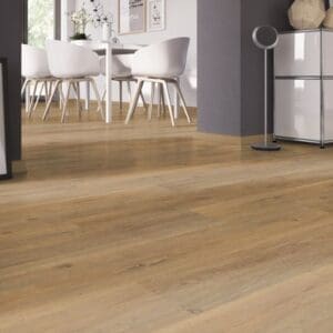Close up of Royal Oak Natural vinyl flooring in a bright dining area with white chairs