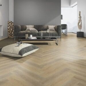 Modern living room featuring Sawcut Oak Natural Herringbone flooring with a grey sofa