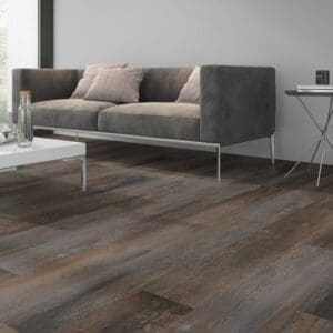 Smoked Pine Brown flooring installed in a modern living room with a grey sofa