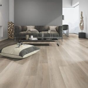 Soft Oak Greige flooring installed in a modern living room with grey sofa