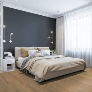 Tyrol Oak Natural flooring installed in a modern bedroom with grey walls