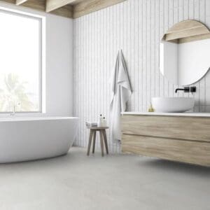Modern white bathroom featuring Waystone Pearl vinyl flooring with a freestanding bathtub and wooden vanity