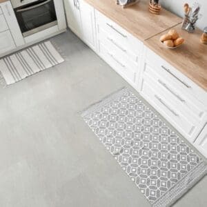 Bright kitchen area with white cabinetry and Waystone Pearl stone effect flooring tiles