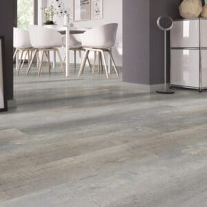 Low angle view of Worn Oak Greige vinyl flooring in a contemporary dining area