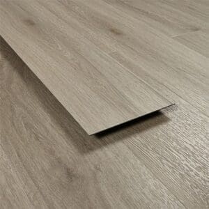 Angled view of a single Urban Grey vinyl plank showing thickness