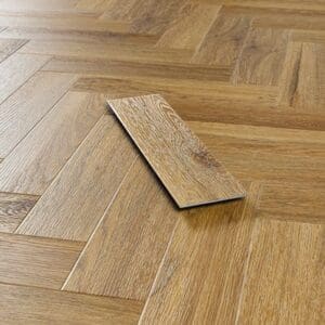 Close up perspective of a single Abingdon Mosaic Brushed Oak plank being laid on a herringbone floor