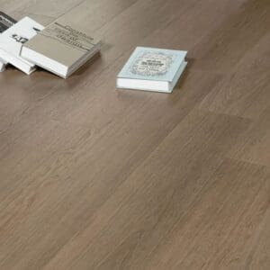 Close up of Autumn Chestnut planks on a floor with books showing the natural wood grain detail