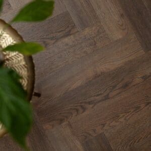 Overhead view of Burnt Fig Herringbone luxury vinyl tiles showing wood grain detail