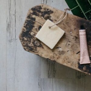 Cove wood effect planks installed in a bathroom with a bowl of bath salts