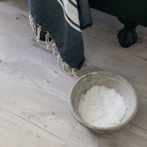 Harvey Maria Cove wood effect flooring in a living room with a leather armchair