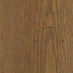 Harvey Maria Fumed English Oak plank flooring installed in a stylish living room with a white armchair