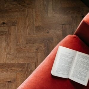 Detailed view of the herringbone installation pattern of fumed oak vinyl tiles