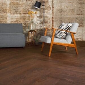 Harvey Maria Burgundy Oak flooring installed in a modern living room with grey furniture