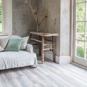 Wide angle view of Harvey Maria Driftwood Plank flooring in a bright room with natural light