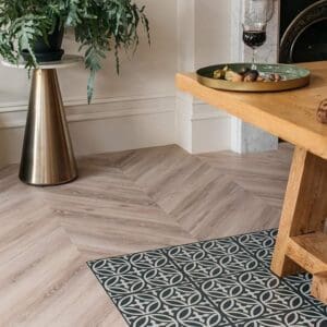 Detailed view of the chevron pattern on Earl Grey luxury vinyl flooring