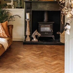 Detail of English Oak Parquet flooring with a perimeter border strip against a dark wall