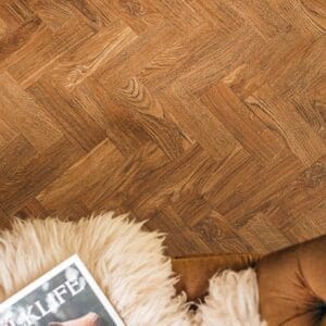 English Oak Parquet flooring installed in a living room with a fireplace and sofa