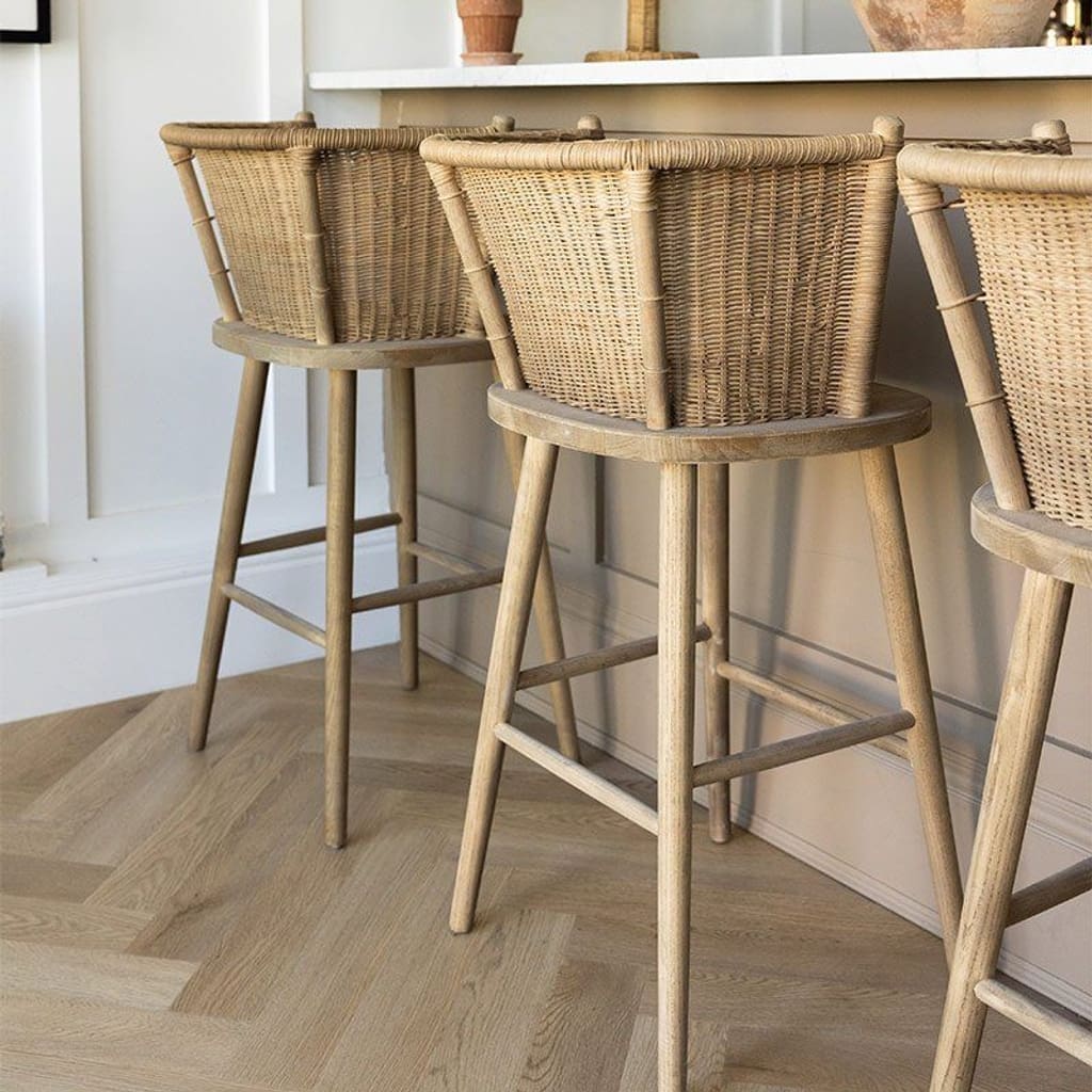 Wide shot of Farro Herringbone flooring in a bright living area with neutral decor.