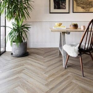 Wide shot of a dining area featuring Harvey Maria Flaxen Oak Herringbone flooring